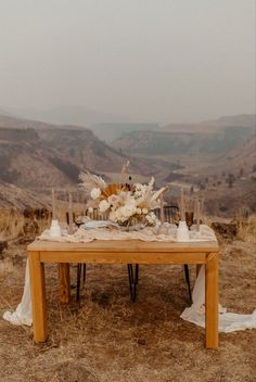 a wooden table topped with flowers and candles