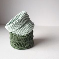 three green crocheted baskets stacked on top of each other