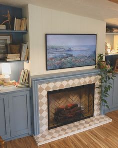 a living room with a fire place and bookshelves on the wall above it