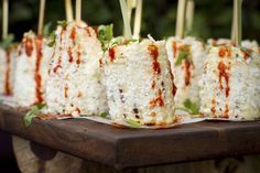 several skewered food items on a wooden tray