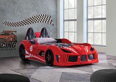 a red sports car bed in a room