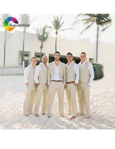 a group of men standing next to each other on top of a sandy beach with palm trees in the background