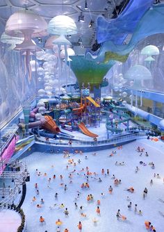 an indoor water park filled with lots of people