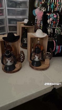 three wooden boxes with different items in them on a white counter top next to other jewelry and bracelets