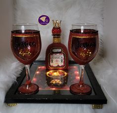 two wine glasses sitting on top of a tray