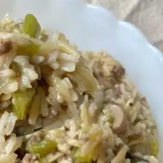 a white bowl filled with rice and vegetables