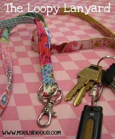 there is a pink and white checkered table cloth with keychains on it