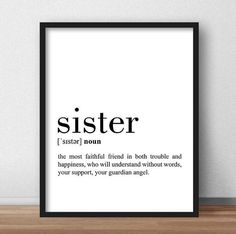 a black and white poster with the words sister on it, sitting next to a wooden table