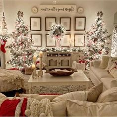 a living room filled with white furniture and christmas trees in the background, surrounded by holiday decorations