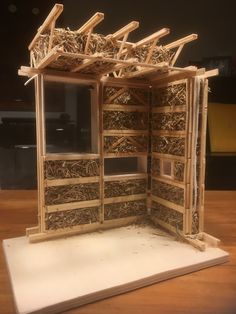 a wooden structure made out of sticks and wood shavings