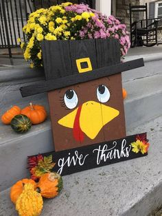 a wooden sign that says give thanks with a turkey on it