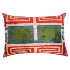 a red and green pillow with squares on the front, sitting on a white background