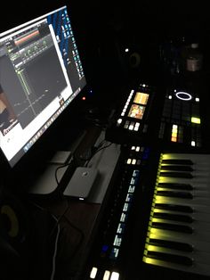 a computer monitor sitting on top of a desk next to keyboard keys and headphones