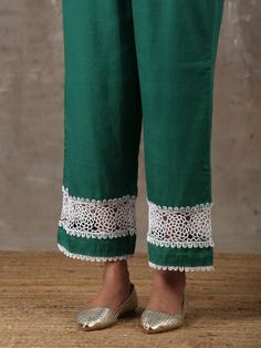 A two piece kurta set comprises of a soft cotton emerald green kurta with crochet fabric details insert on the sleeves along with delicate laces around the body. It is paired with matching culottes with crochet fabric details and lace detailing on the edges. Color: Emerald Green Fabric Composition: Kurta Set - Soft cotton Note: The product will be delivered within 20-25 days of order placed Care Instruction: Dry Clean Only. Do not use heavy Iron