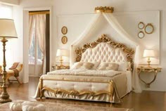 a fancy bedroom with white and gold furniture