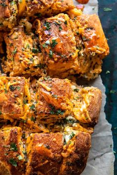 several pieces of bread with cheese and herbs on top