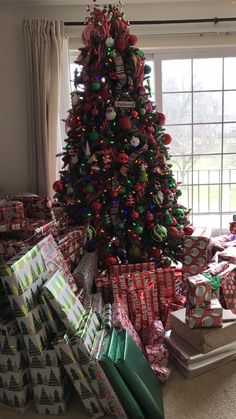 a christmas tree with many presents under it