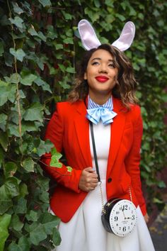 a woman wearing bunny ears and holding a clock