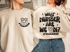 Keep track of performances in style with our 'What Number Are We On? #DanceMom' Sweatshirt - the perfect attire for dance moms who are always on the go, supporting their dancers at every step of their journey.  HOW TO ORDER: 1. Choose size/color options 2. Select the quantity 3. Click "Add to Cart" 4. Proceed to payment Sweatshirt Features: - Premium blend Organic Cotton  - Relaxed fit/ Unisex - Available in sizes S - 5XL Care Instructions: To keep your sweatshirt looking its best, follow these Cheerleading Mom, Mom Crewneck, Vip Club, Mom Sweater, Dance Mom, Mama Gifts, Dance Competition, Mom Sweatshirt, Copy Paste