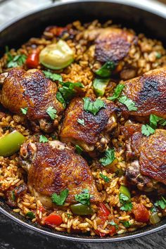 a skillet filled with rice and meat covered in herbs, garnished with parsley