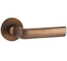 an antique brass door handle on a white background