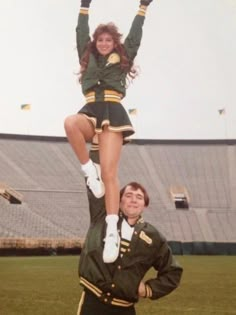 two cheerleaders are doing tricks on the field