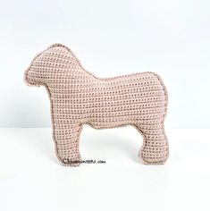 a crocheted horse is standing on a white surface and looks like it's made out of yarn