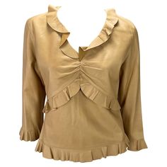 Presenting a saddle-colored leather ruffled Gucci top, designed by Tom Ford. From the Spring/Summer 1999 collection, fabric versions of this top debuted on the season's runway. This incredible top is constructed entirely of soft lightweight leather in saddle color. The shirt features cropped sleeves, a v-neckline, and ruching at the bust. Made complete with ruffle details at the neckline, waist, hem, and cuffs this late 1990s top is the perfect addition to any Tom Ford Gucci lover's wardrobe. Ap Gucci By Tom Ford, Tom Ford Gucci, Gucci Top, Saddle Brown, V Neck Blouse, Tom Ford, S S, Saddle, Spring Summer