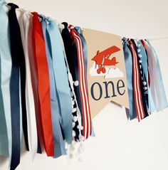 some ribbons are hanging on the wall and one is red, white, and blue