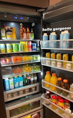 an open refrigerator with drinks and juices in it's door, showing the shelves