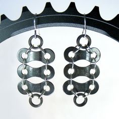 "Black bike links and rollers, with contrasting silver jump rings, make up this fun design. I used \"Tava\" chain, which has been disassembled and thoroughly cleaned, with the brand name visible, enhancing the authenticity of the pieces. (Not all links have stampings--it can be random) The earrings hang about 1.5\" from the lobe, and have great movement. These are sure to delight bike lovers and serious riders!  The earrings hang from sterling silver ear wires. Can be made to order with silver, Bicycle Chain Jewelry, Black Bike, Bicycle Chain, Bike Chain, Link Earrings, Bike Lovers, Chain Links, Chain Jewelry, Fun Design