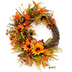 a wreath with orange flowers and apples on it