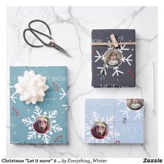 three christmas cards with snowflakes on them next to a pair of scissor