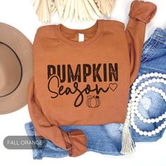 Description: Celebrate the essence of fall with our "Pumpkin Season" Sweatshirt! Decked in a vibrant fall orange, this cozy pullover is perfect for pumpkin patch visits, casual fall outings, or just lounging at home surrounded by the scent of spiced pumpkin lattes. Embrace the season with style and comfort! Orange Crew Neck Top For Fall, Orange Long Sleeve T-shirt For Fall, Orange Crew Neck T-shirt For Fall, Orange Letter Print T-shirt For Fall, Orange T-shirt With Letter Print For Fall, Orange Relaxed Fit Tops For Fall, Orange Cotton Sweatshirt For Fall, Orange Cotton Top For Fall, Orange Cotton Tops For Fall