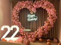 a heart - shaped balloon arch with the number twenty two in front of it