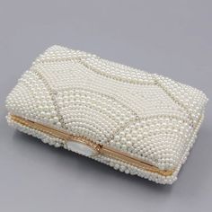 The Violeta Luxury Pearl Clutch Bag has a stunning and luxurious look. This bag is made of high-quality materials and has enough space for your essentials while still looking elegant at the same time. Its embroidered exterior bespeaks its beauty, while its exquisite frame demonstrates luxury. Exclusively available in c Luxury Rectangular Cosmetic Bag For Formal Occasions, Luxury Rectangular Cosmetic Bag For Formal Use, Rectangular Evening Bag With Pearl Handle, White Rectangular Clutch, Rectangular Evening Bag With Pearl Embroidery For Gift, Formal Pearl Handle Clutch Box Bag, Rectangular Evening Bag With Pearl Embroidery, Formal Clutch Box Bag With Pearl Handle, Chic Rectangular Coin Purse For Formal Occasions