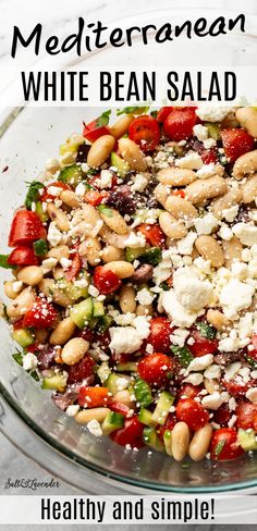 white bean salad with strawberries and feta cheese in a glass bowl