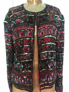 "Festive sequin silk jacket; padded shoulders, long sleeves, one tiny hook at the neck. Red  lining; made in India, size large. Papell Boutique Shoulder seam to wrist 24 1/2\" Neck to waist 22\" Armpit to armpit 19\" Great condition, inside and out SHOP THE STORE:  https://www.etsy.com/shop/BrocanteBedStuy?"