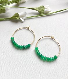 Emerald Hoop Earrings. Ten faceted emeralds adorn each hoop for a total of 20 emeralds in these beautiful earrings! These are perfect with jeans and a t-shirt or to wear with your best outfit! The hoops measure 1-1/4 inches in length and width or just over 3 cm. These earrings are available in either gold plated or rhodium plated finish. Emerald is the May birthstone. Your emerald hoop earrings will arrive gift boxed. If this is a gift, I would be glad to include a card with your personal messag May Birthstone Round Hoop Earrings, May Birthstone Round Hoop Earrings For Pierced Ears, Small Hoop Earrings With Faceted Beads For Gift, Hoop Jewelry With Faceted Beads For Gifts, Small Hoop Jewelry With Faceted Beads For Gifts, Faceted Hoop Earrings As Gift, Gift Hoop Earrings With Faceted Beads, Elegant Hoop Earrings With Faceted Beads, Faceted Beads Dangle Hoop Earrings For Gifts