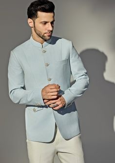 Presenting the stunning Light Blue Bandhgala Jacket Set, crafted from a premium wool blend that exudes elegance and modern sophistication. The blue bandh gala, designed with a textured finish, features a sleek mandarin collar and a buttoned front, offering a refined, tailored look. Paired with off-white trousers, this ensemble strikes the perfect balance between tradition and contemporary fashion. Its versatile color and high-quality material ensure both comfort and durability, making it a must- Blue Bandhgala, Vacuum Storage, Indian Wedding Wear, White Trousers, Buy Lights, Wedding Wear, Contemporary Fashion, Mandarin Collar, Formal Event