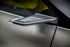 an electronic device is attached to the door handle of a car's side view mirror