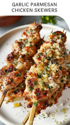 grilled chicken skewers with garlic parmesan sauce on a white plate