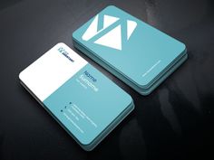 two business cards sitting on top of a black table with blue and white designs in the middle