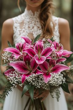 a woman holding a bouquet of pink lilies