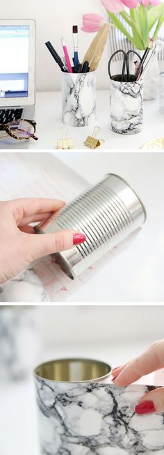 a woman's hand is holding a can with some pens and pencils in it