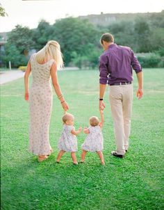 a man and woman holding hands with two small children