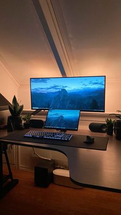 a desk with a laptop and monitor on it