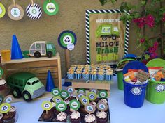 a table topped with cupcakes and desserts