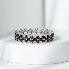 Product Details Enhance your style with the sparkling beauty of this black spinel ring, designed to bring a touch of glamour to your life. The round-cut black spinel, securely nestled in a prong setting on a full eternity band, adds versatility to this exquisite piece, making it suitable for any outfit or occasion. Product Information SKU SHP-RINGS0821188905 Width 2.7 mm Height 4.8 mm Weight 2.72 gm (Approximate) BLACK SPINEL INFORMATION No.of Stones 57 Pieces Total Weight 1.71 Carat (Approximat