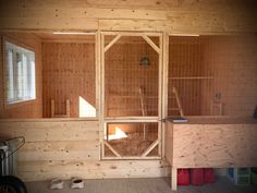 the inside of a chicken coop with wooden walls